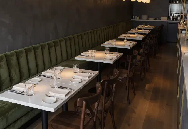 Banquette seating and bentwood chairs in a restaurant dining room
